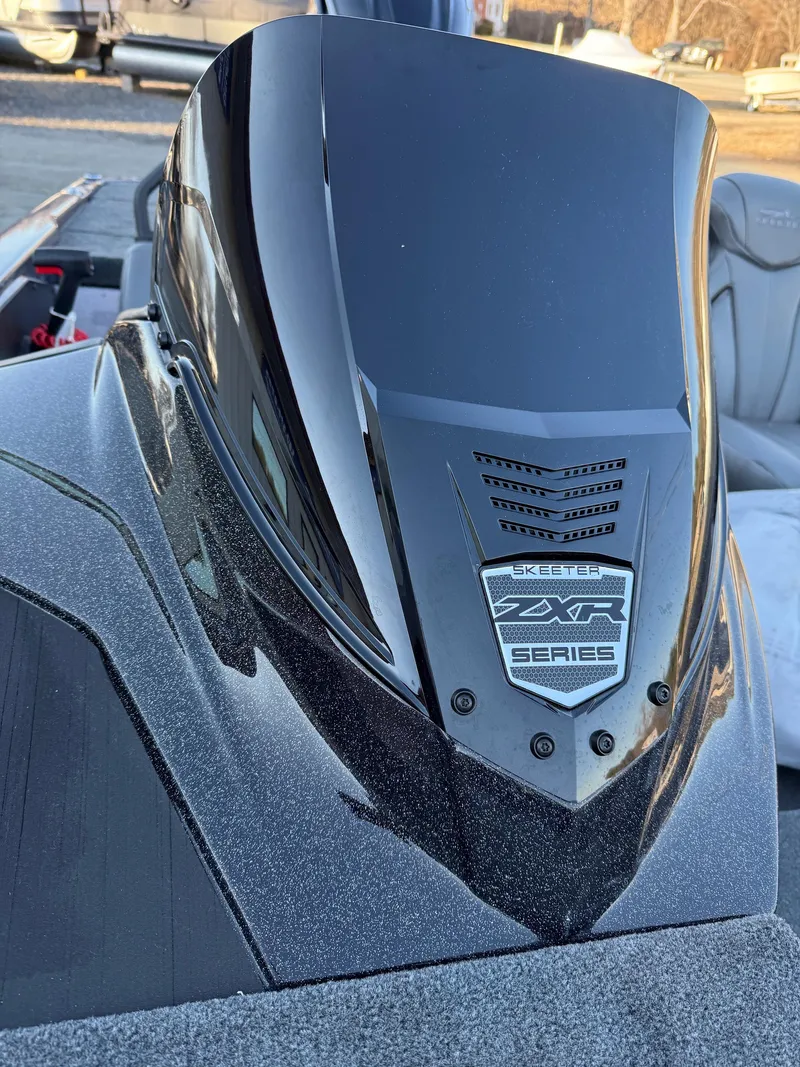 Slide: The Image of 2025 Skeeter ZXR 20 SE boat, sleek black design, close-up of the front panel. - 8