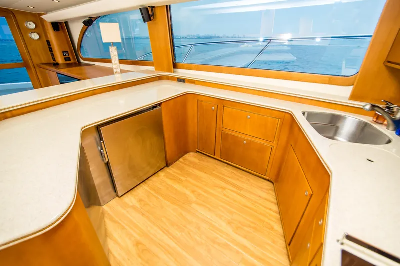 Slide: The Image of Luxurious 2003 Donzi R65 yacht kitchen with wood cabinetry and ocean view. - 10