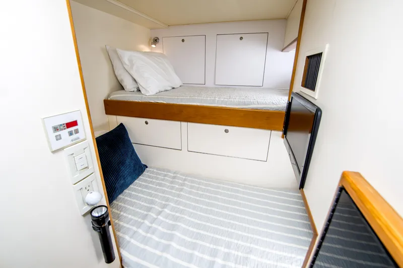 Slide: The Image of Compact cabin with bunk beds in a 2003 Donzi R65 boat. - 13