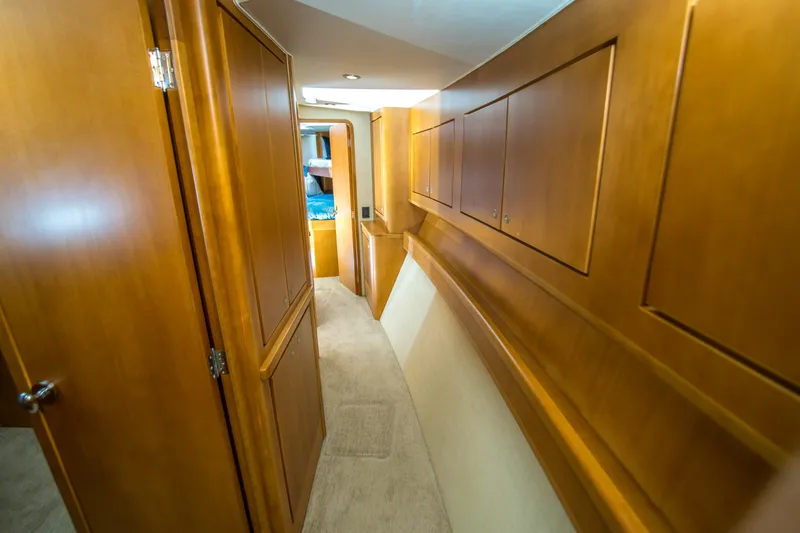 Slide: The Image of Interior hallway of 2003 Donzi R65 yacht with wooden cabinetry and carpeted floor. - 15