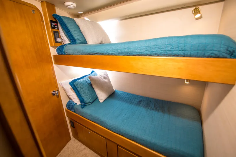 Slide: The Image of Bunk beds with blue bedding in a 2003 Donzi R65 yacht cabin. - 16