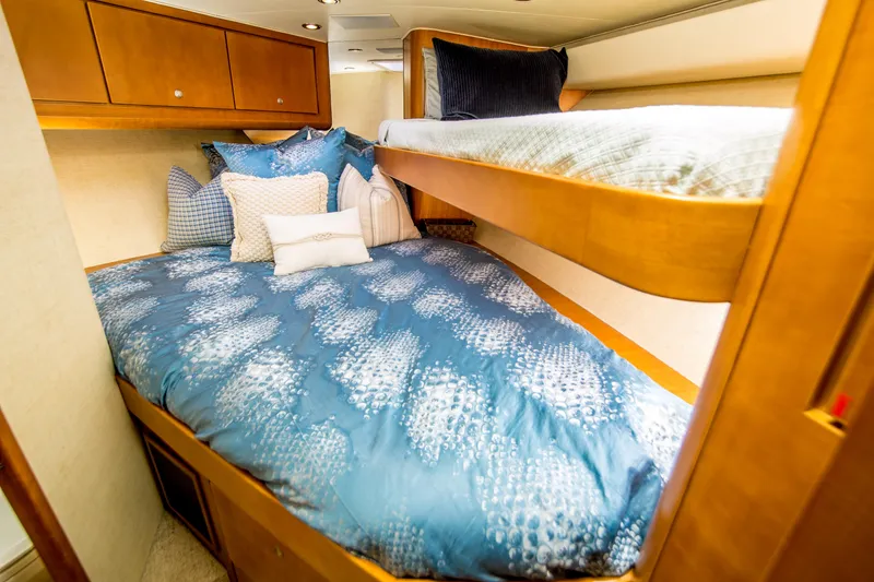 Slide: The Image of Cozy cabin interior of 2003 Donzi R65 with blue bedding and wooden accents. - 17