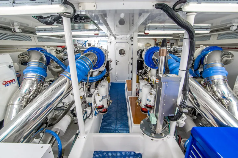 Slide: The Image of Engine room of a 2003 Donzi R65 yacht, featuring advanced machinery and blue accents. - 20
