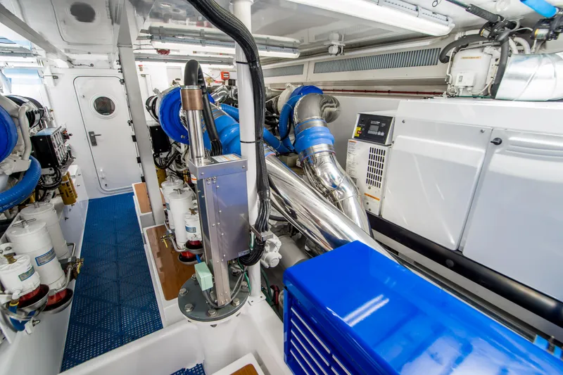 Slide: The Image of Engine room of a 2003 Donzi R65 boat, featuring blue and silver components. - 21
