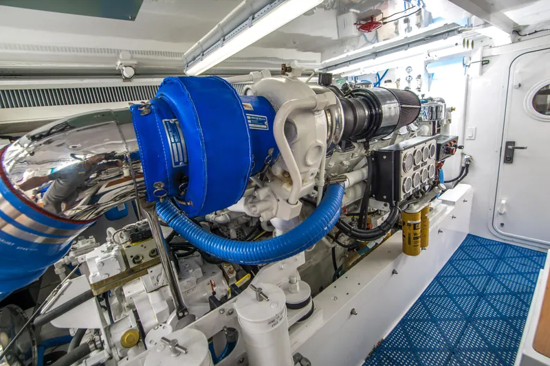 Slide: The Image of Engine room of a 2003 Donzi R65 yacht, featuring a powerful marine engine. - 22