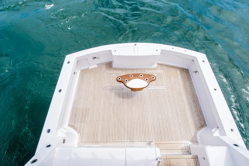 Slide: The Image of 2003 Donzi R65 boat deck with wooden flooring on blue water. - 3