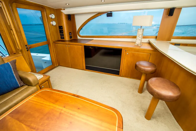 Slide: The Image of Luxurious interior of 2003 Donzi R65 yacht with wooden furnishings and ocean view. - 8