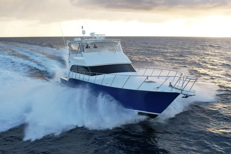 The Image of 2003 Donzi R65 yacht cruising on open ocean at sunset. - 0