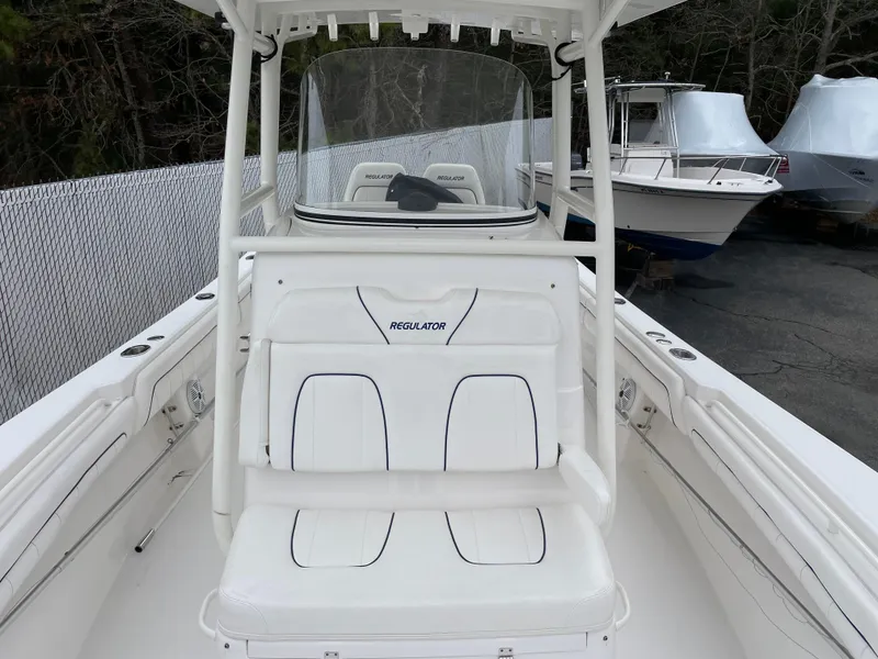 Slide: The Image of 2016 Regulator 28 boat interior with white seating and console. - 15