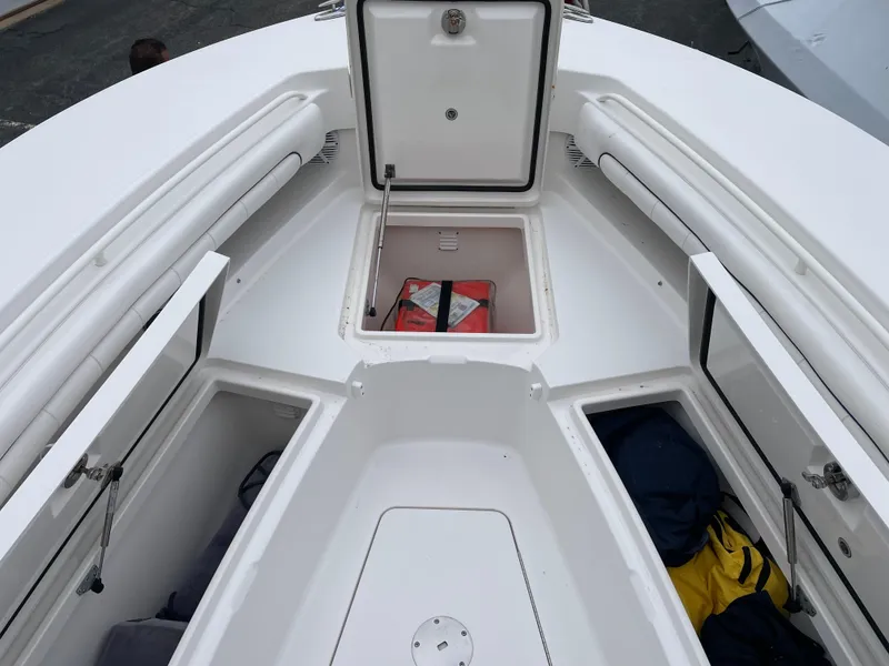 Slide: The Image of 2016 Regulator 28 boat with open storage compartments and life jackets. - 16