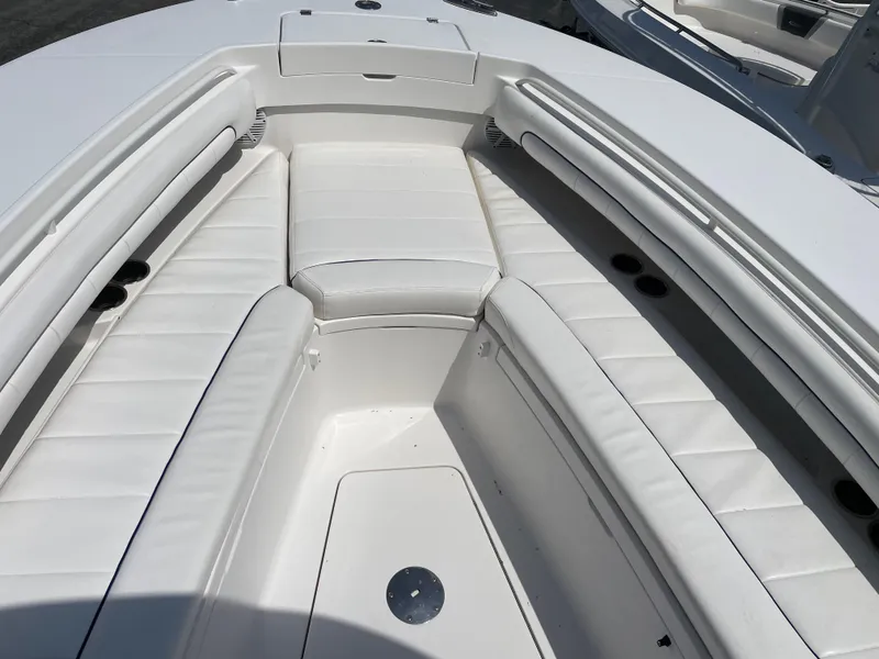 Slide: The Image of 2016 Regulator 28 boat with white cushioned seating in the bow area. - 17