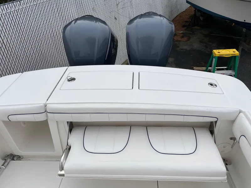 Slide: The Image of 2016 Regulator 28 boat with dual outboard engines and white seating area. - 19