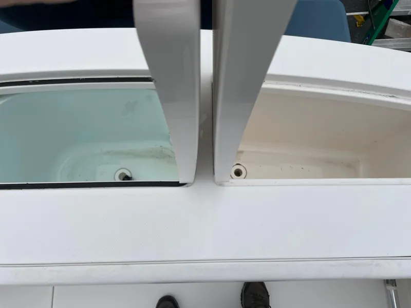 Slide: The Image of 2016 Regulator 28 boat compartments, one filled with water, showcasing storage features. - 20