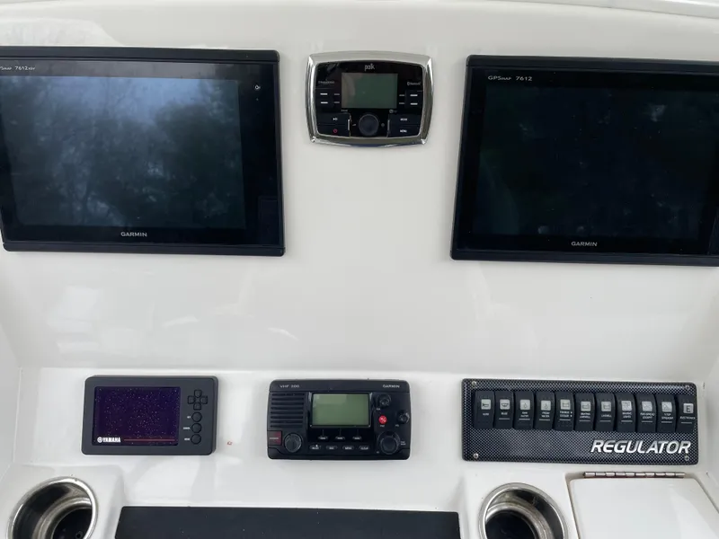 Slide: The Image of Control panel of a 2016 Regulator 28 boat with electronic displays and switches. - 5