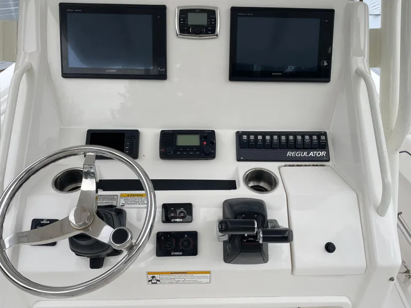 Slide: The Image of Control panel of a 2016 Regulator 28 boat with steering wheel and electronic displays. - 6