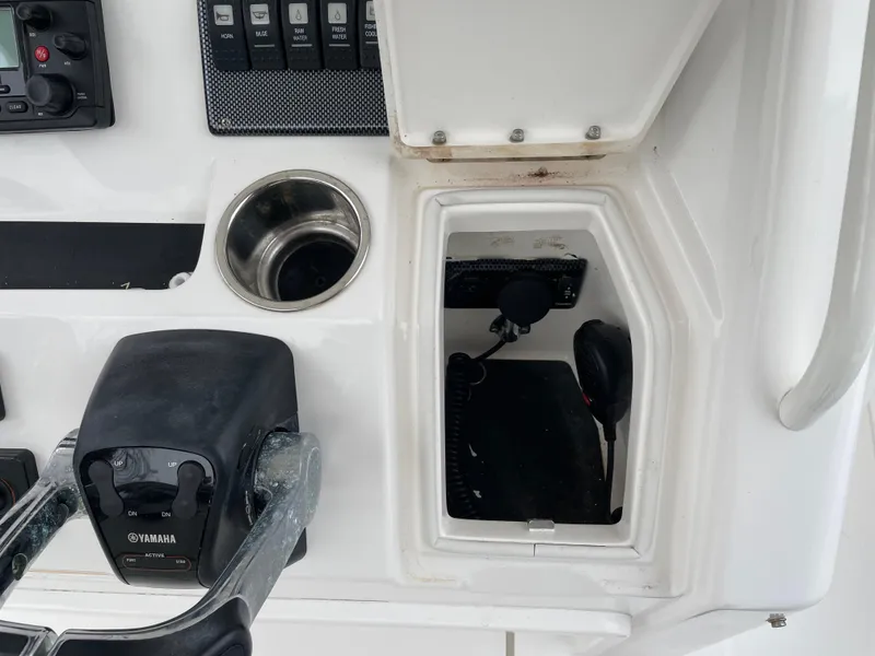Slide: The Image of Control panel of a 2016 Regulator 28 boat with Yamaha throttle and cup holder. - 7