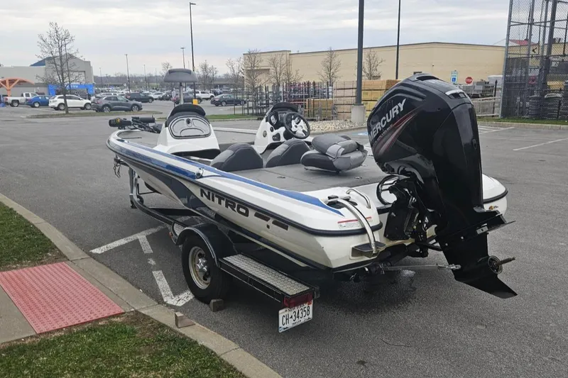 Slide: The Image of 2015 Nitro Z6DC boat with Mercury engine in parking lot. - 2