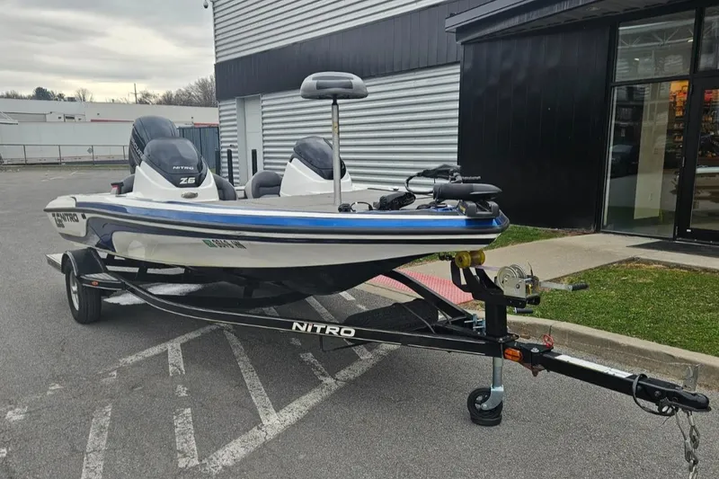 Slide: The Image of 2015 Nitro Z6DC boat on trailer, parked outside a building. - 3