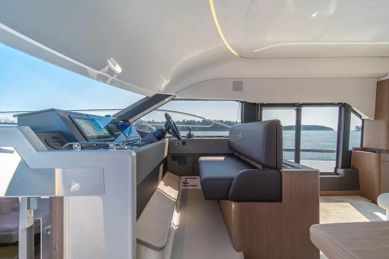 Slide: The Image of Luxurious interior of 2025 Prestige F4.9 yacht with modern helm and panoramic windows. - 38