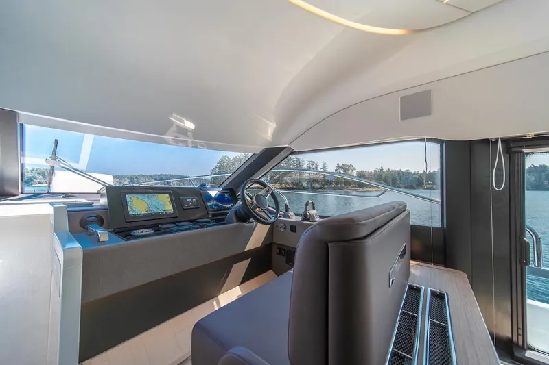 Slide: The Image of Luxurious interior of 2025 Prestige F4.9 yacht with modern navigation system. - 40