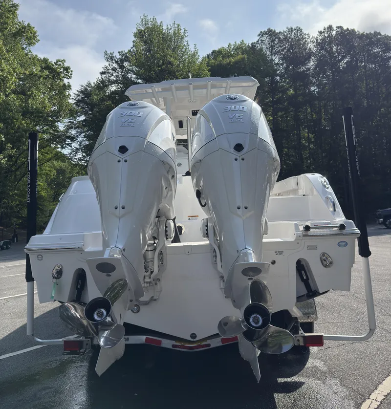 Slide: The Image of 2025 Sea Fox 288 Commander boat on trailer, surrounded by trees. - 1