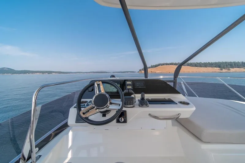 Slide: The Image of Helm of 2025 Prestige F4.9 yacht with scenic ocean view. - 24