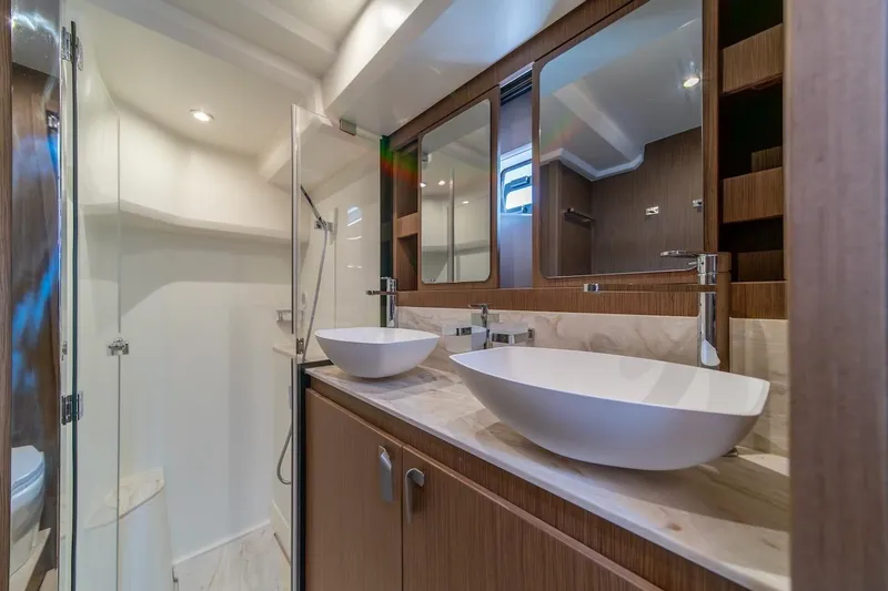 Slide: The Image of Luxurious bathroom in 2025 Prestige F4.9 yacht with dual sinks and modern fixtures. - 28
