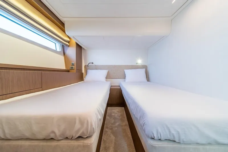 Slide: The Image of Luxurious twin cabin interior of 2025 Prestige F4.9 yacht, featuring modern design and comfort. - 34