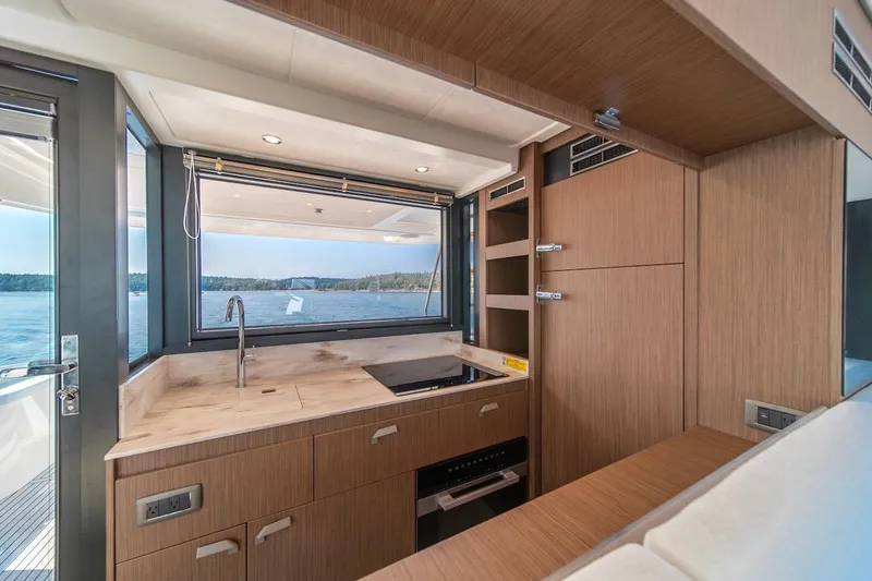 Slide: The Image of Modern kitchen interior on Prestige F4.9 yacht, 2025 model, with scenic water view. - 44