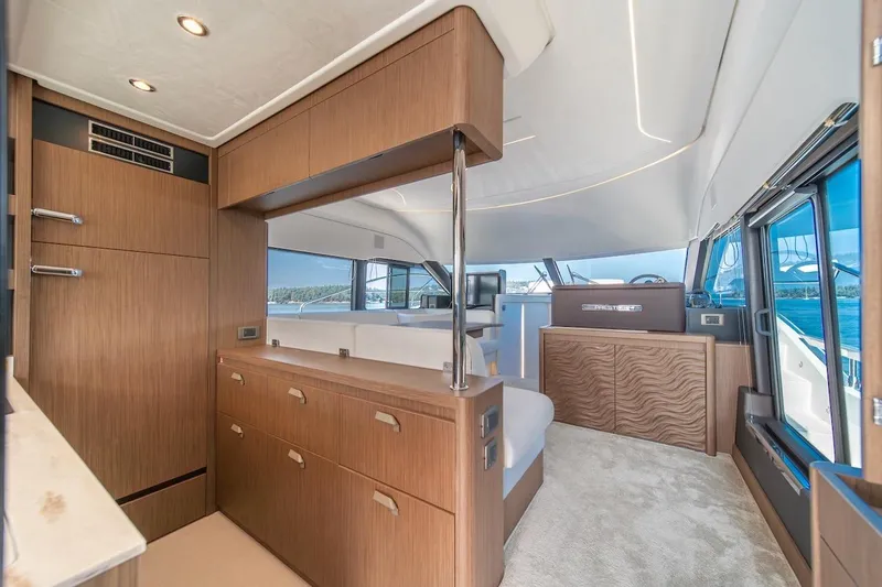 Slide: The Image of Luxurious interior of 2025 Prestige F4.9 yacht with modern wood finishes and panoramic windows. - 47