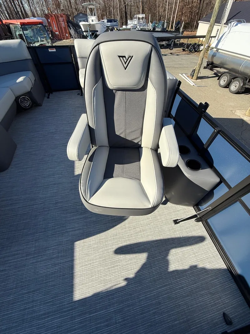 Slide: The Image of 2025 Viaggio V22U boat seat with armrests, gray upholstery, and cup holder on deck. - 16