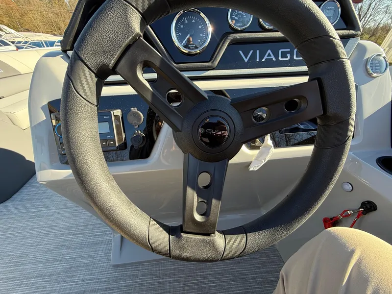 Slide: The Image of Steering wheel of a 2025 Viaggio V22U boat with dashboard controls. - 20