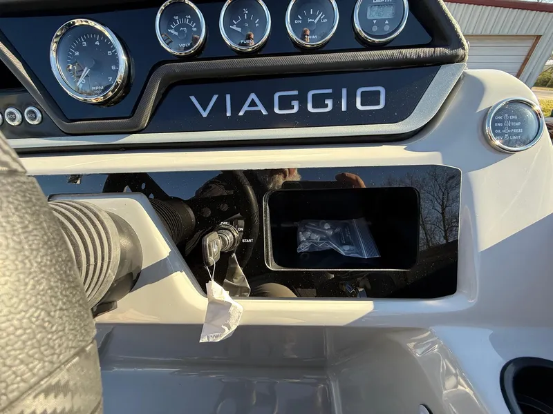 Slide: The Image of Control panel of 2025 Viaggio V22U boat with gauges and storage compartment. - 22