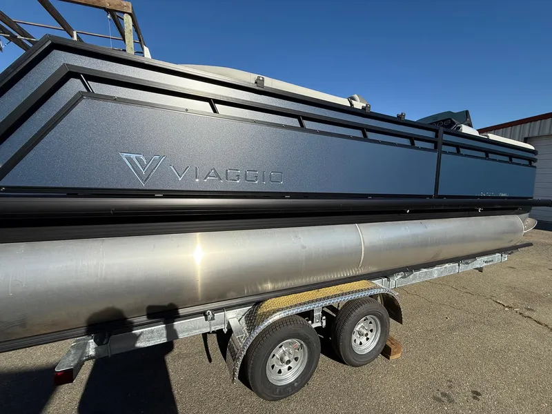 Slide: The Image of 2025 Viaggio V22U pontoon boat on trailer under clear blue sky. - 9