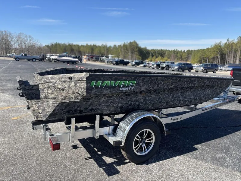 Slide: The Image of Camouflage-patterned Havoc RDBST 1553 boat on trailer, 2025 model, in parking lot. - 6