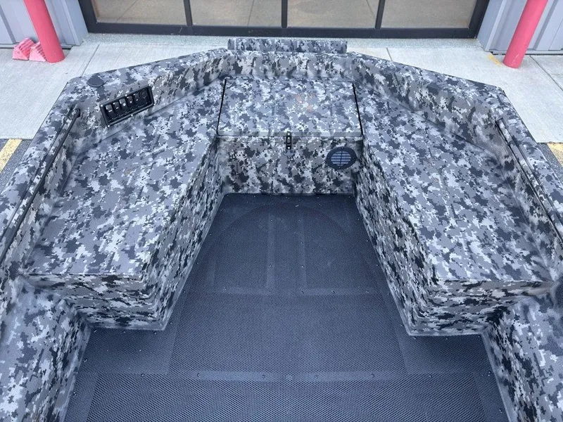 Slide: The Image of Interior of 2025 Havoc RDBST 1553 boat with camo design and storage compartments. - 13