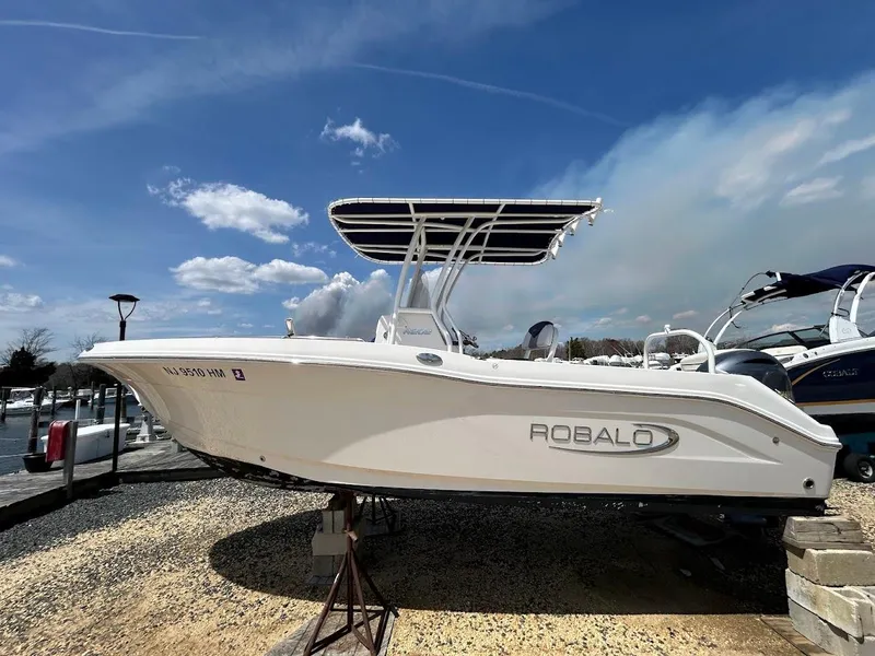 Slide: The Image of 2019 Robalo R202EX boat displayed outdoors under a blue sky. - 1