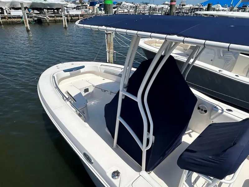 Slide: The Image of 2019 Robalo R202EX boat docked, featuring a sleek design and spacious seating area. - 4