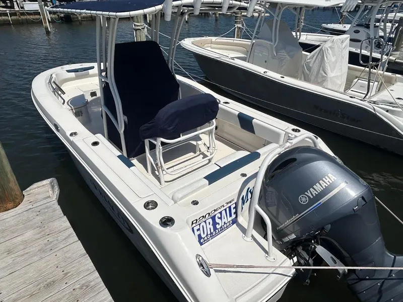 Slide: The Image of 2019 Robalo R202EX boat with Yamaha engine, docked and for sale sign visible. - 5