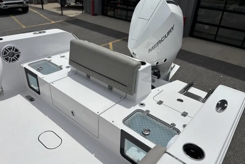 Slide: The Image of 2025 Sportsman Heritage 231 boat interior with Mercury engine, featuring seating and storage compartments. - 10