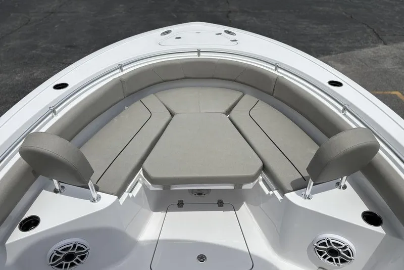 Slide: The Image of 2025 Sportsman Heritage 231 boat interior with cushioned seating and speakers. - 12