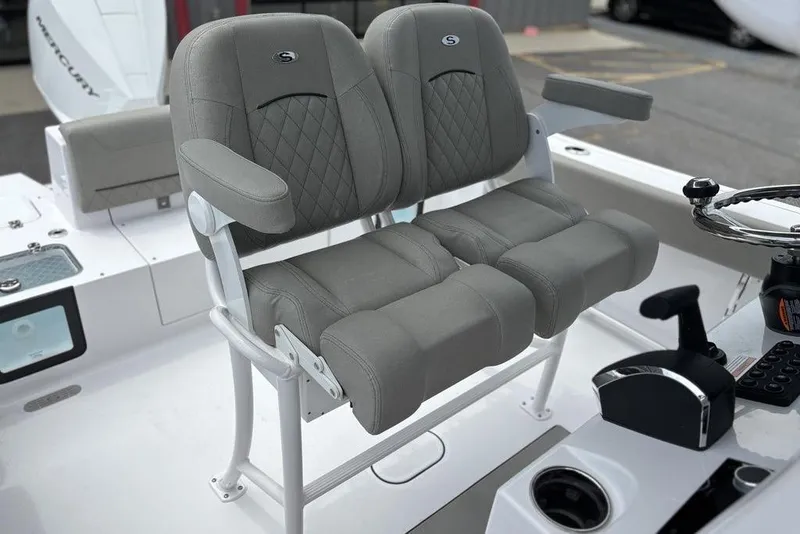 Slide: The Image of 2025 Sportsman Heritage 231 boat seats with armrests and steering console. - 15