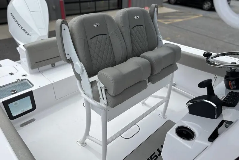 Slide: The Image of 2025 Sportsman Heritage 231 boat interior with dual cushioned seats and steering console. - 19