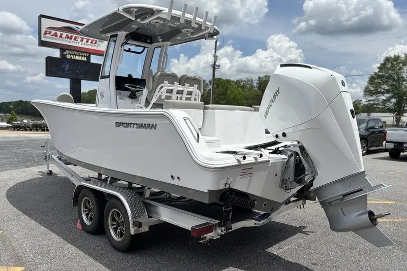 Slide: The Image of 2025 Sportsman Heritage 231 boat on trailer, displayed outdoors under cloudy sky. - 4