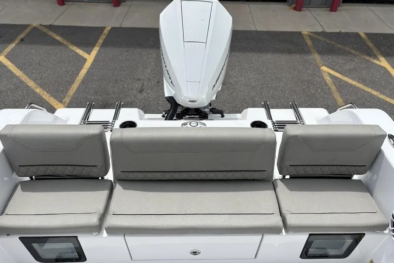 Slide: The Image of 2025 Sportsman Heritage 231 boat with cushioned seating and outboard motor. - 7