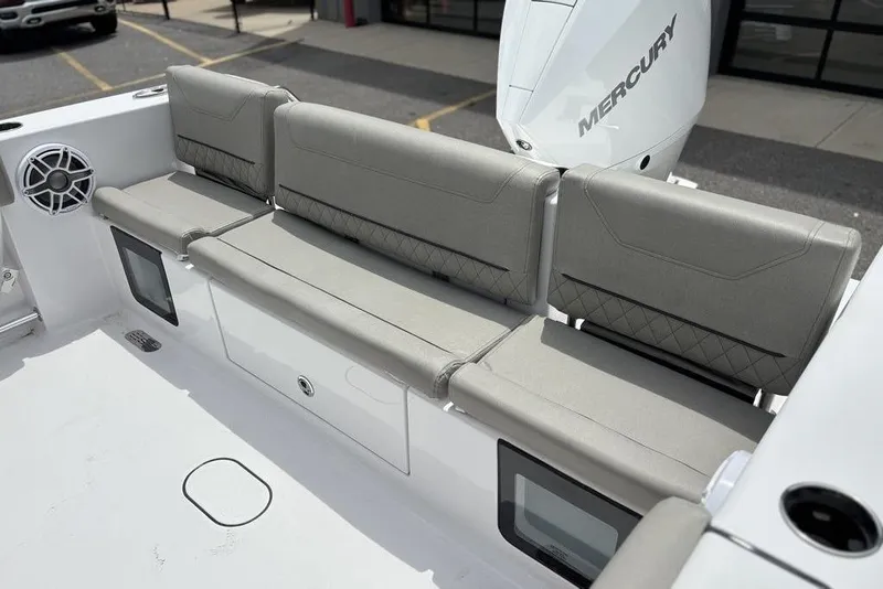 Slide: The Image of 2025 Sportsman Heritage 231 boat seating with Mercury engine, featuring gray cushioned seats. - 9