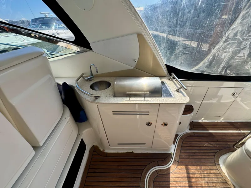 Slide: The Image of 2009 Sea Ray 350 Sundancer interior with sink and wooden flooring. - 13