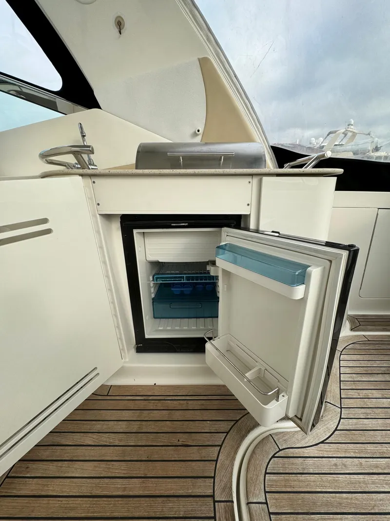 Slide: The Image of 2009 Sea Ray 350 Sundancer yacht with open mini fridge on deck. - 14