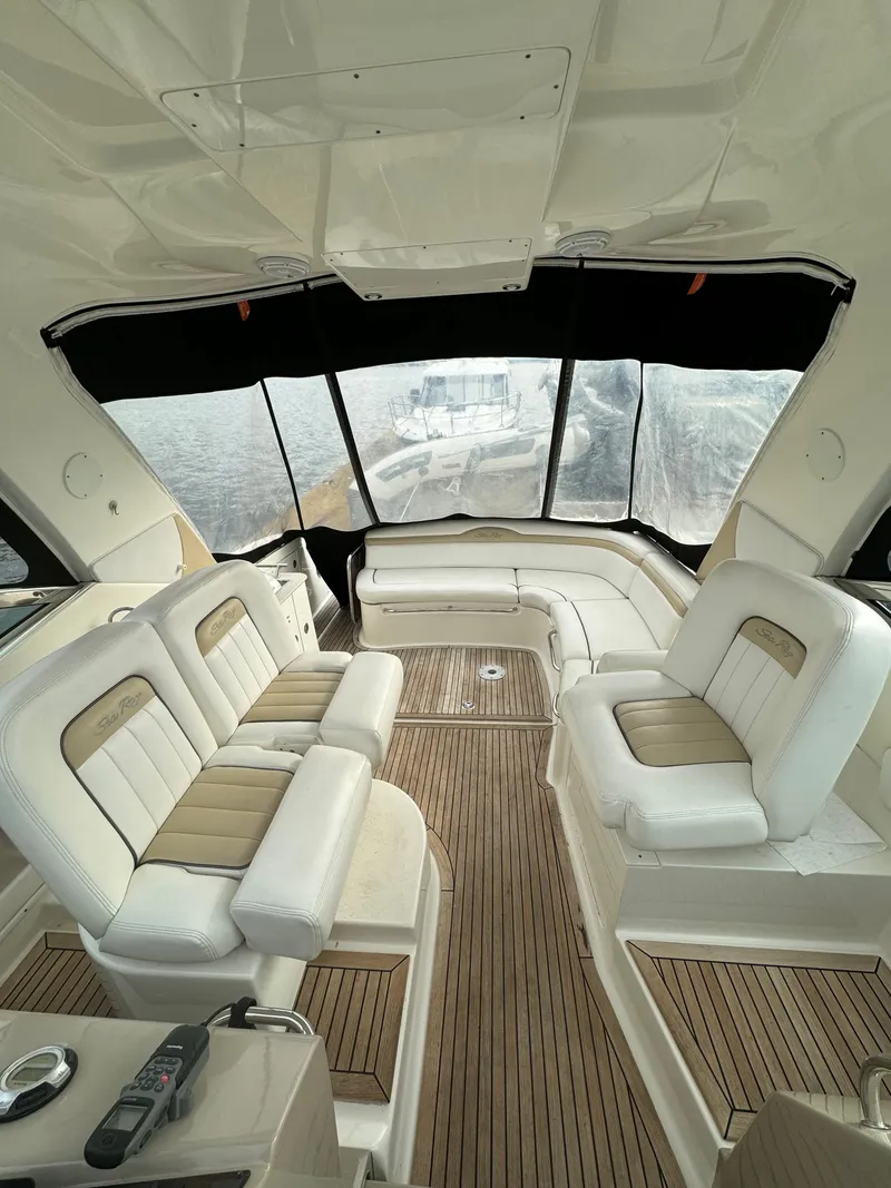 Slide: The Image of Interior of 2009 Sea Ray 350 Sundancer yacht with plush seating and wood flooring. - 15