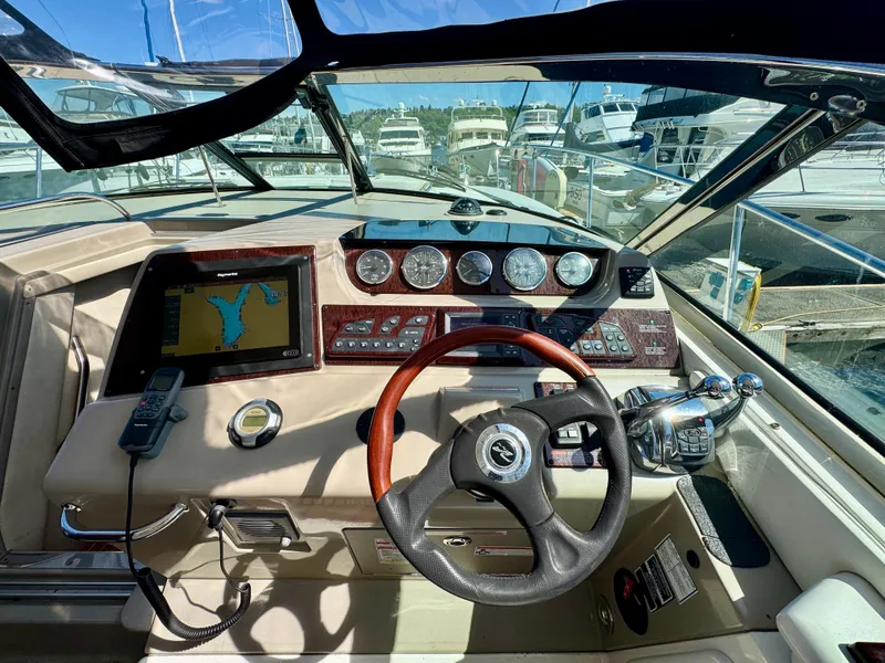 Slide: The Image of Cockpit of 2009 Sea Ray 350 Sundancer with navigation system and steering wheel. - 16
